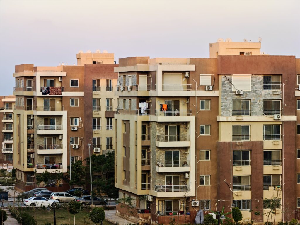 Urban residential buildings with balconies and air conditioning units.